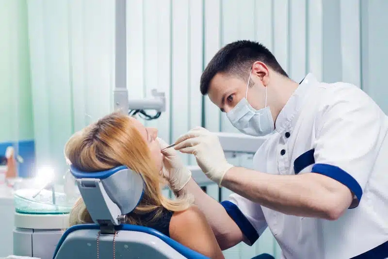 Ballantyne Orthodontist Examining A Patient’s Teeth In A Dental Office